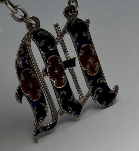 An early Victorian silver wine label, the letter 'M' enamelled in red and blue on wide suspension ch