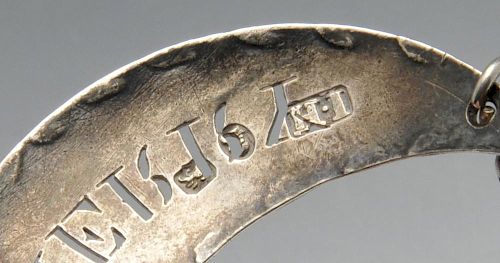 A George III silver sherry wine label, of pierced crescent form. Hallmarked John Hutson, London, pro