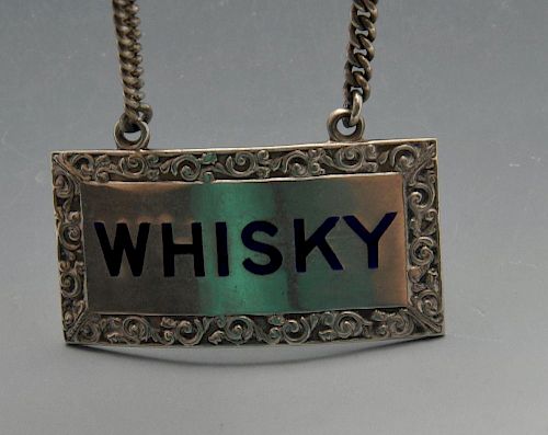 A modern silver whisky label of oblong form with enamel inlay within scroll surround. Hallmarked Tur