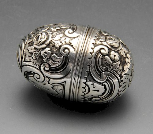 An eighteenth century nutmeg grater, the ovoid form with floral and scroll embossed decoration. Appe