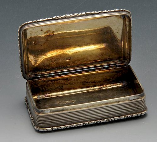 An early Victorian silver snuff box, the rounded rectangular form with floral scroll borders enclosi