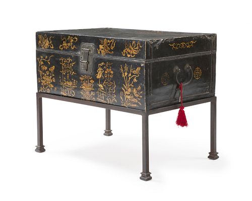 A Chinese black lacquered leather trunk on stand