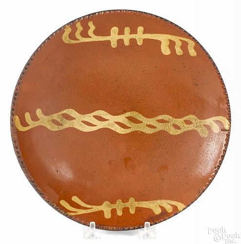 Pennsylvania redware pie plate, 19th c., with yellow slip decoration, 9'' dia.