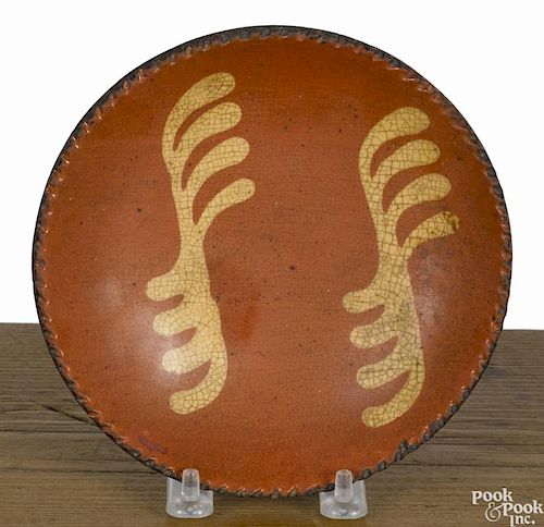 Small Pennsylvania redware pie plate, 19th c., with yellow slip decoration, 6 1/8'' dia.
