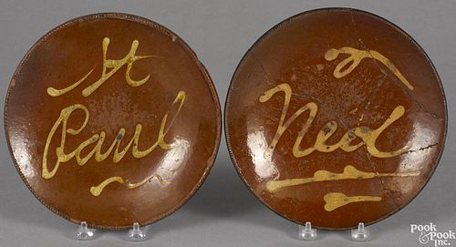 Two Connecticut redware plates, 19th c., with slip inscriptions St. Paul and Ned, 9'' dia.