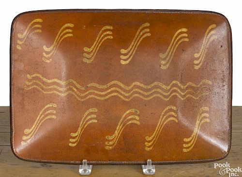 Redware loaf dish, 19th c., with yellow slip decoration, 10 1/4'' h., 14 5/8'' w.