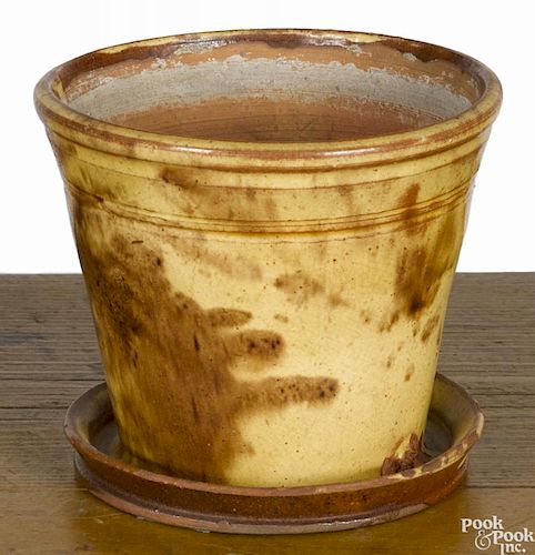 Two Pennsylvania redware flower pots, 19th c., each with attached undertray, 4 3/4'' h. and 6'' h.