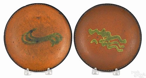 Two Pennsylvania redware plates, 19th c., with green slip decoration, each - 7 1/4'' dia.