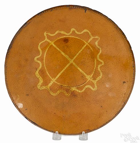 Huntington, Long Island redware charger, 19th c., with a central slip circle and star device