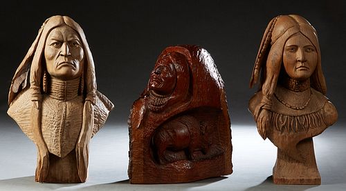 Group of Three Carved Wooden Native American Heads, 20th c., consisting of a matching man and woman on tapered square plinths, and a male bust over a 