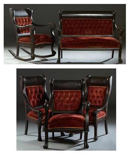 American Late Victorian Carved Mahogany Five Piece Parlor Suite, c. 1900, consisting of a settee, rocking armchair, two armchairs, and a lady's chair,