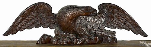 Carved pine spread winged eagle, ca. 1835, retaining an old mahogany stained surface, 9'' h.