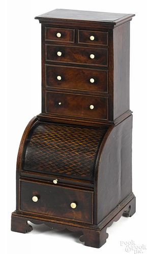 Miniature English mahogany roll front secretary desk, ca. 1800, with a parquetry inlaid lid