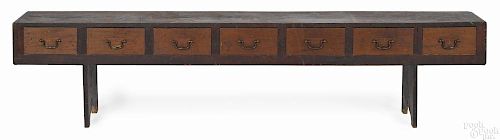 Unusual Pennsylvania poplar bench, late 19th c., with a bank of seven drawers