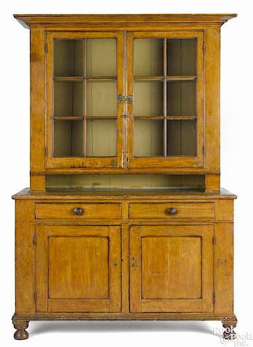 Pennsylvania painted pine Dutch cupboard, ca. 1830, retaining an old ochre grained surface