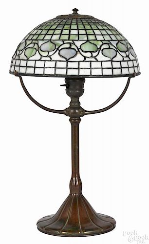 Tiffany Studios patinated bronze table lamp with a leaded glass leaf and vine shade