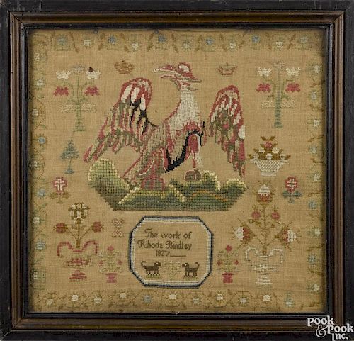 Silk on linen sampler, dated 1827, wrought by Rhoda Bindley, with a large spread winged eagle