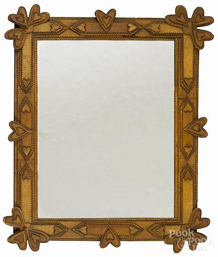 Tramp art carved mirror, ca. 1900, with applied hearts, overall - 28 1/2'' x 22 1/2''.
