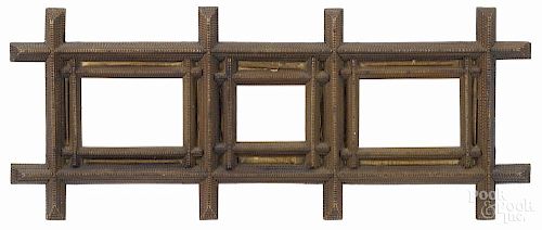Tramp art carved triple frame, ca. 1900, with rolled newspaper panels, overall - 13'' x 31 1/4''.
