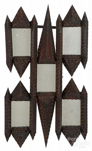 Tramp art carved mirror, ca. 1900, with five mirror plates, overall - 30 1/2'' x 17 1/2''.