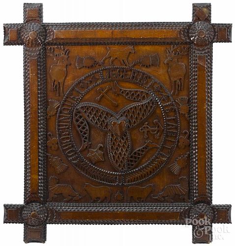Unusual tramp art carved plaque, ca. 1900, depicting the coat of arms of the Isle of Man