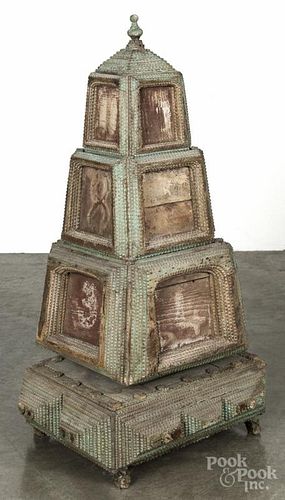 Unusual tramp art carved and painted revolving pyramid portrait cabinet, ca. 1900, with two drawers