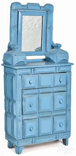 Tramp art carved and painted child's dresser, ca. 1900, retaining a blue surface, 46'' h., 21'' w.