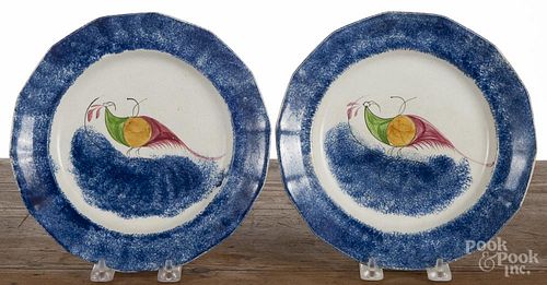 Pair of blue spatter peafowl plates, 19th c., 9'' dia., together with a similar plate, 8 1/2'' dia.