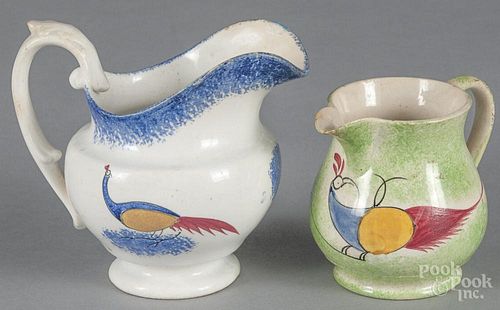 Two spatter peafowl cream pitchers, 19th c., to include a blue example, 4 3/4'' h.