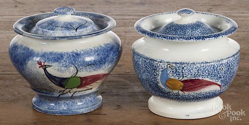 Two blue spatter peafowl sugar bowls, 19th c., 4 1/2'' h. and 4 3/4'' h.
