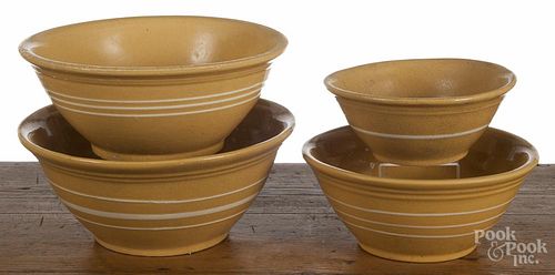 Assembled nest of four yelloware mixing bowls, 19th c., with white slip bands, largest - 5'' h.