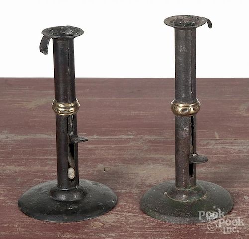 Two tin wedding band hogscraper candlesticks, 19th c., 7 3/4'' h. and 8'' h.