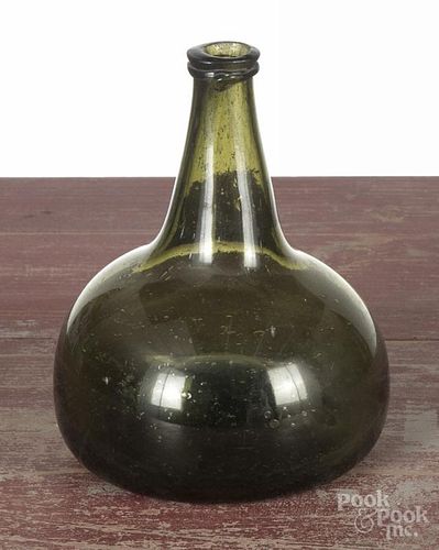 Two aqua glass bottles, 18th c., to include a Dutch onion wine bottle, 7'' h., and a mallet bottle