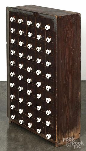 Primitive pine apothecary cabinet, 19th c., having ten rows of five drawers
