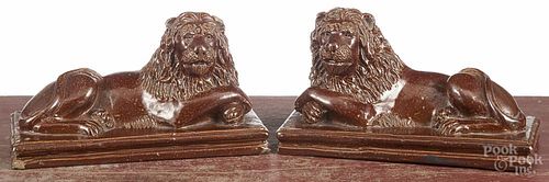 Pair of sewer tile recumbent lions, initialed B. M. 1908, 5 1/2'' h., 9 3/4'' w.