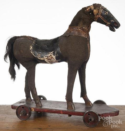 Horse pull toy, 19th c., with burlap covering and iron wheels, 22'' h., 20 1/2'' l.