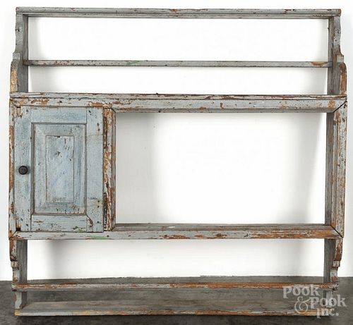 Continental painted pine hanging pewter shelf, 19th c., with a single raised panel door