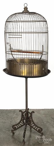 Large Hendryx brass floor model bird cage, ca. 1900, with a cast iron base, 64'' h.
