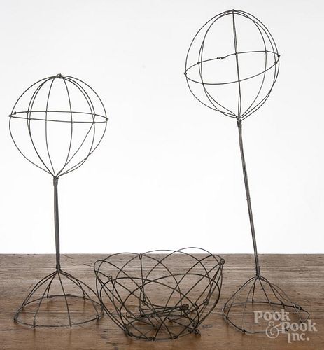 Two wire hat stands, ca. 1900, 21'' h. and 17'' h., together with a hanging wire basket, 4 1/2'' h.