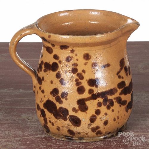 Continental redware pitcher, 19th c., with manganese splotching, 6'' h.