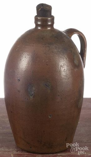 Four New England stoneware jugs, 19th c., tallest - 11 3/4'', together with a redware crock