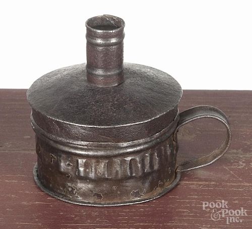 Tin tinder box candle holder, ca. 1800, with a flint and steel striker, 3 1/2'' h.