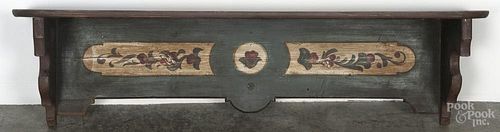Painted pine hanging shelf, 19th c., with a later floral decoration on a green background, 13'' h.
