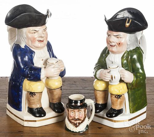Two Staffordshire figural Toby jugs, 19th/20th c., 11'' h. and 10 1/2'' h.