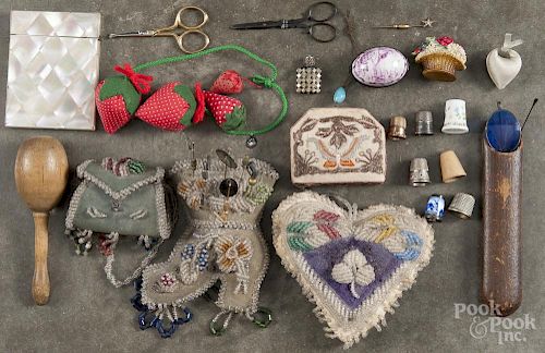 Sewing articles, 19th/20th c., to include a beaded pincushion, a flower basket tape measure