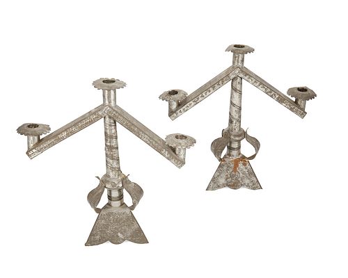 A pair of sand-weighted tin candelabra
