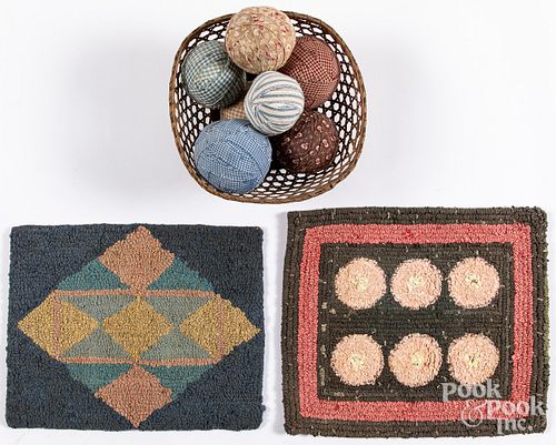 Two small hooked rugs, a basket and fabric balls
