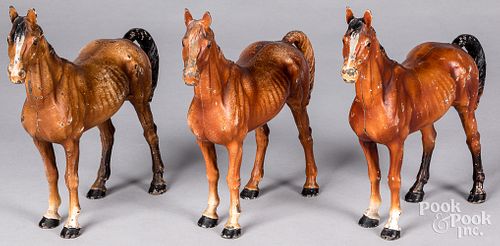 Three painted cast iron horses