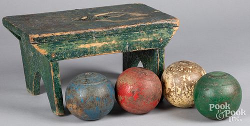 Set of four duckpin bowling balls and a foot stool