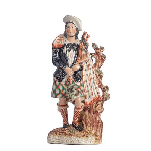 19th century molded figure of a bagpipe player